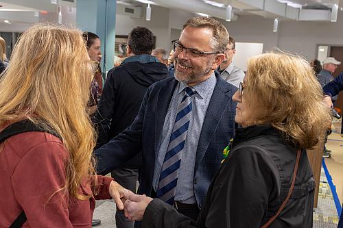 Beloit College President Eric Boynton greets members of the community.